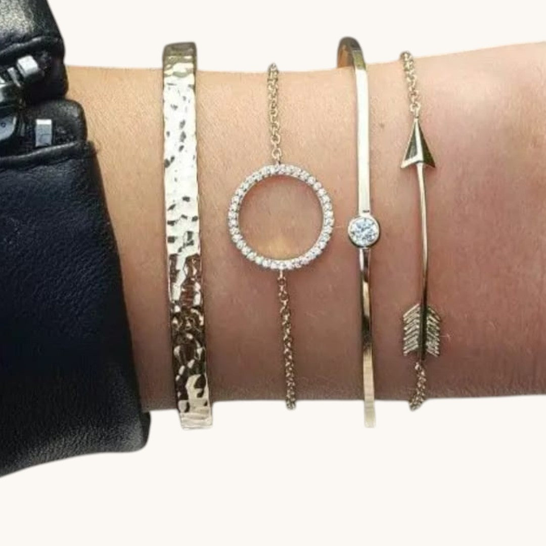 TITLIYA set of four gold-tone bracelets featuring a hammered cuff, circle charm, solitaire, and arrow design.