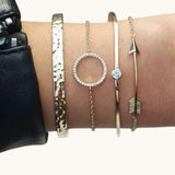 TITLIYA set of four gold-tone bracelets featuring a hammered cuff, circle charm, solitaire, and arrow design.