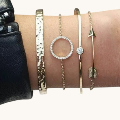 TITLIYA set of four gold-tone bracelets featuring a hammered cuff, circle charm, solitaire, and arrow design.
