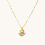 TITLIYA gold-tone shell pendant necklace featuring a central pearl and delicate crystal accents on a link chain.