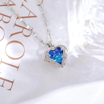 TITLIYA silver plated necklace featuring a blue heart-shaped stone pendant with intricate wing-like detailing.