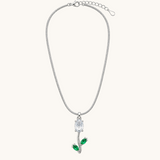TITLIYA silver-tone snake chain necklace featuring a tulip pendant with a white oval stone and green leaf accents.