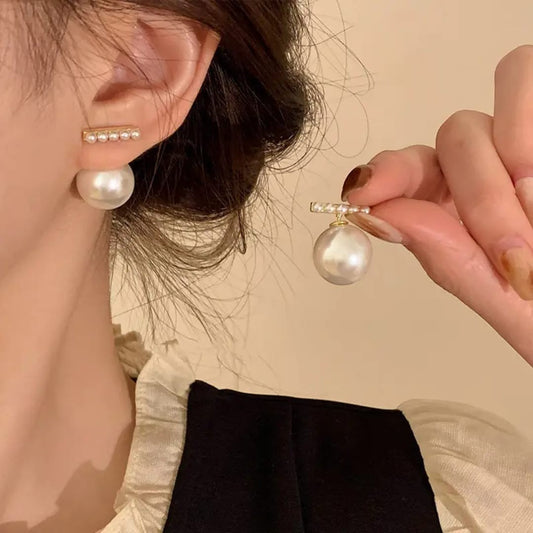 TITLIYA stick bar drop earrings featuring a gold-tone bar with small pearls and a large white pearl drop.