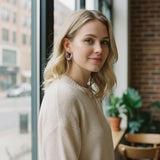 Woman wearing TITLIYA twisted Korean hoop earrings in lavender and gold, styled for an elegant everyday look.