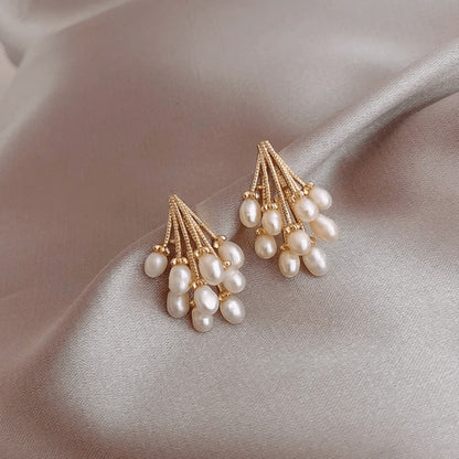 TITLIYA Korean-style gold-tone earrings featuring clusters of white water drop pearls on a soft grey satin background.