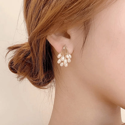 TITLIYA Korean-style water drop pearl cluster earrings in gold, worn by a woman for an elegant daily look.