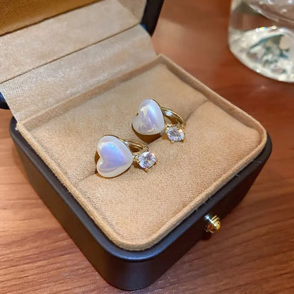 TITLIYA white heart-shaped earrings with sparkling diamond accents in a premium velvet-lined jewelry gift box.