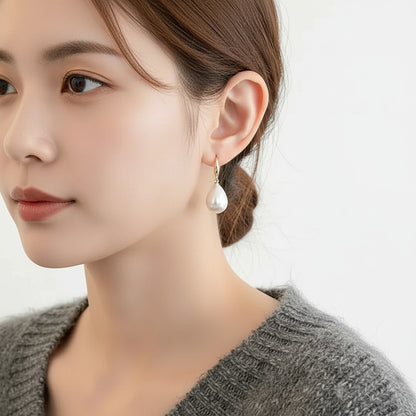 TITLIYA elegant teardrop white pearl earring with gold-tone hook worn by a woman for daily or formal wear.